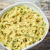 Simple buttered noodles in a serving dish.
