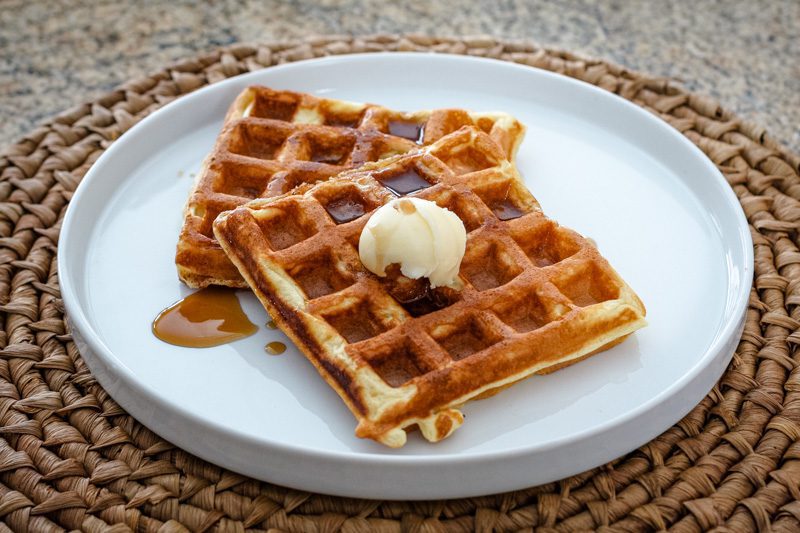 buttermilk waffles with butter and syrup