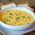 butternut squash soup on a plate with crackers