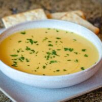 butternut squash soup on a plate with crackers