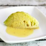 cabbage wedge with lemon sauce on a plate