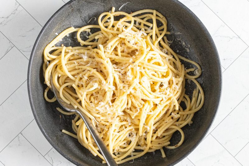 bowl of cacio e pepe pasta with spaghetti and pecorino romano cheese