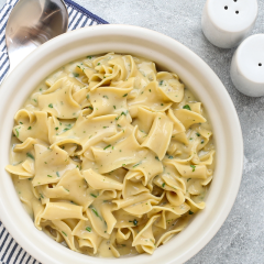 Creamy homemade pasta with herb sauce.