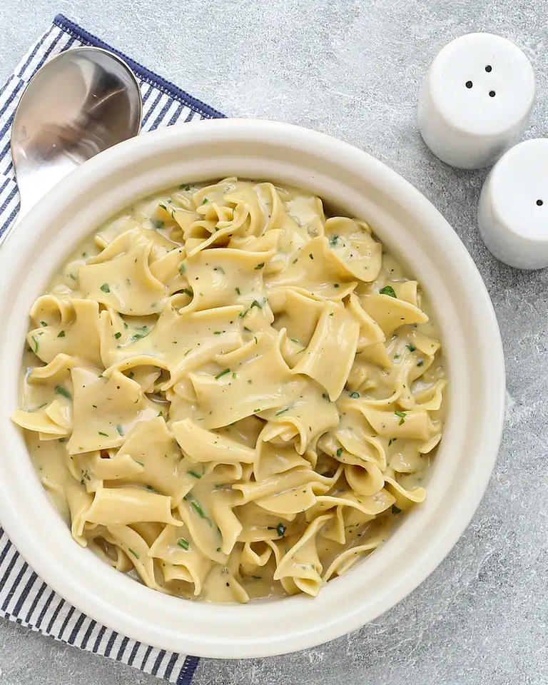 Creamy homemade pasta with herb sauce.