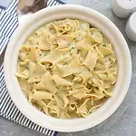 Creamy Alfredo pasta with herbs and cheese.