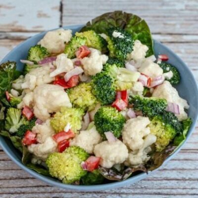 cauliflower and broccoli salad in a serving bowl