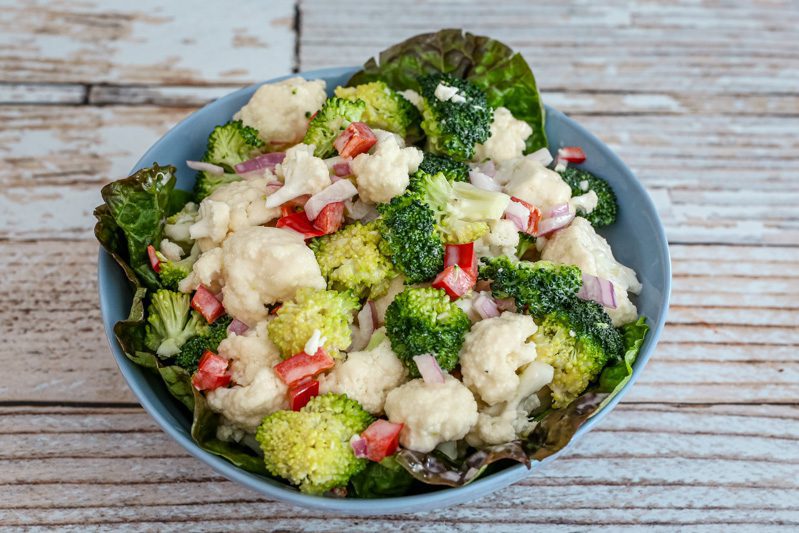 cauliflower and broccoli salad in a serving bowl