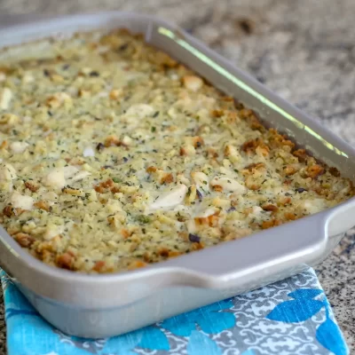 Baked casserole with a golden breadcrumb topping and herbs.
