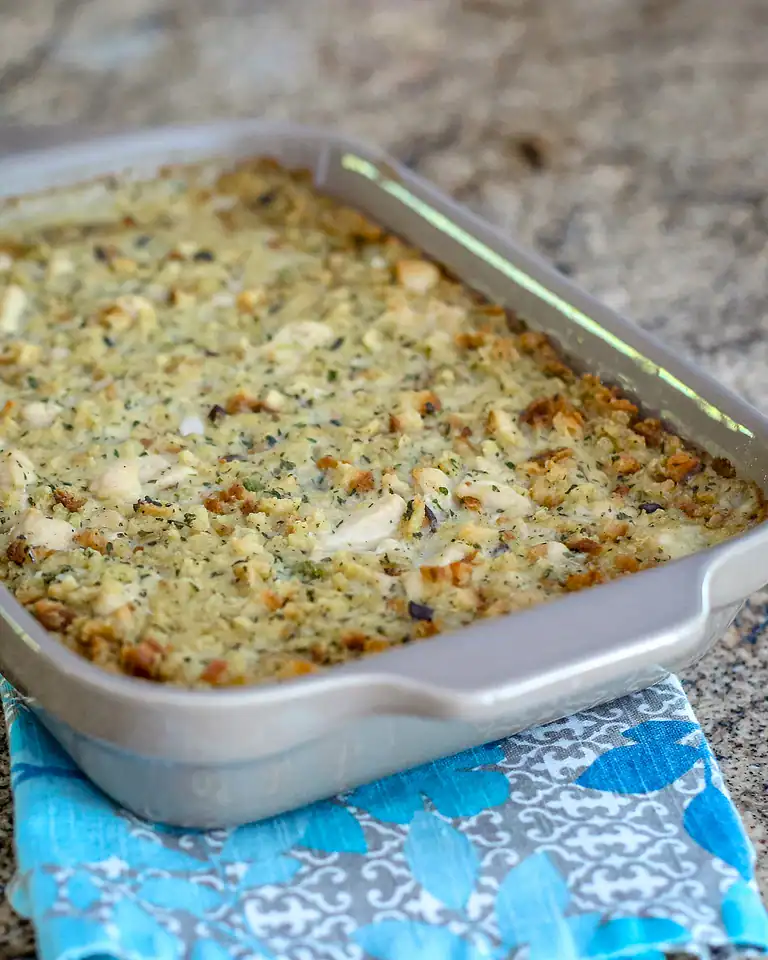 Baked casserole with a golden breadcrumb topping and herbs.
