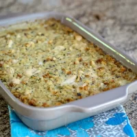 Baked casserole with bread crumbs and herbs on top.