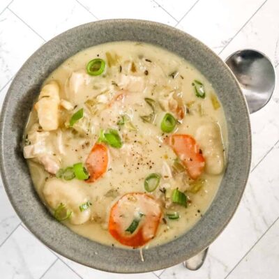 Creamy chicken and vegetable soup with green onions.