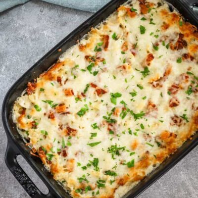 Chicken bacon ranch casserole freshly baked with a cheese and bacon topping.
