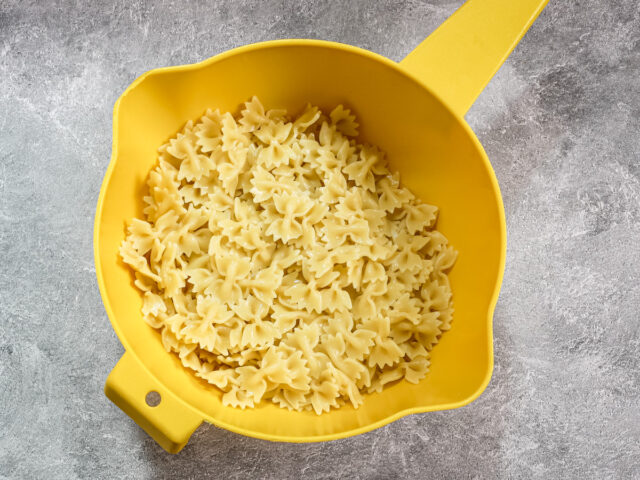 Drained mini farfalle pasta.