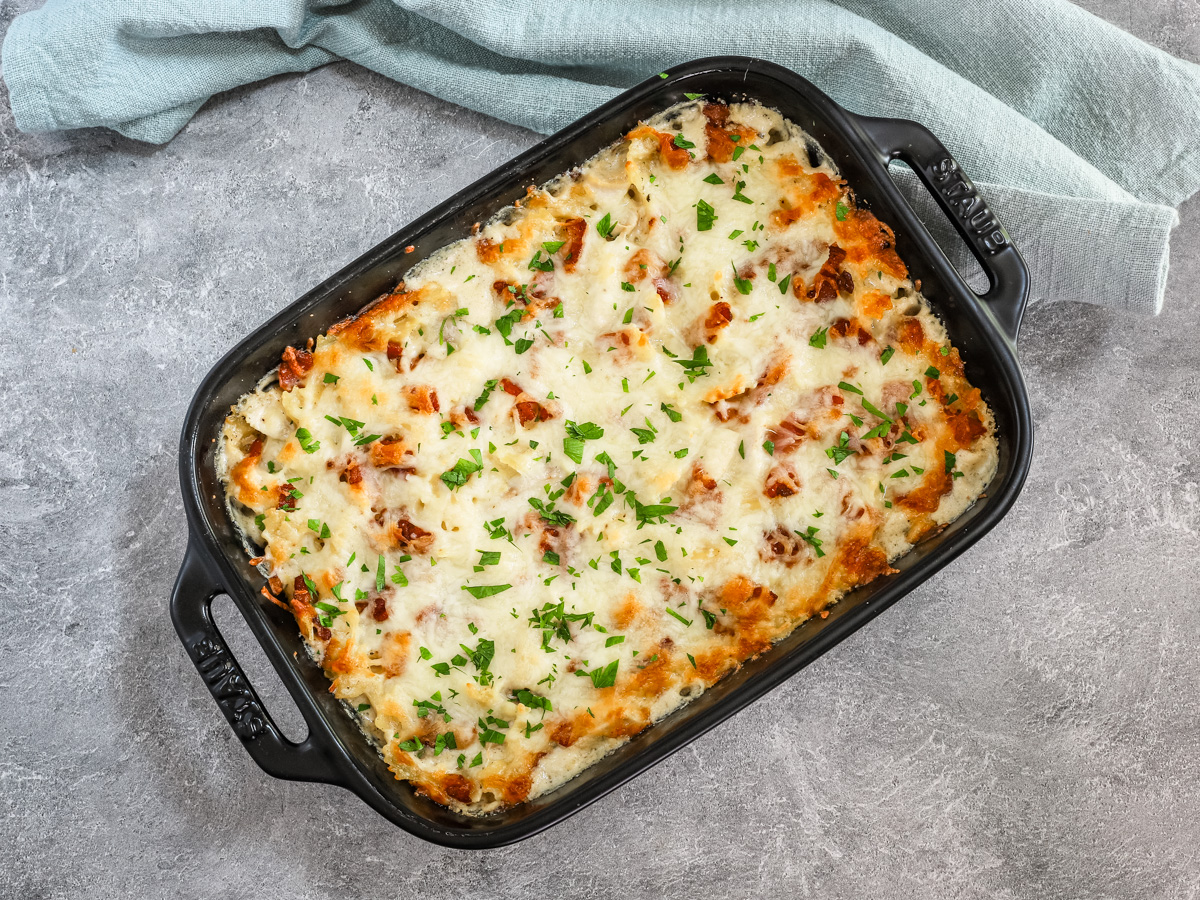 Chicken bacon ranch casserole freshly baked with a cheese and bacon topping.