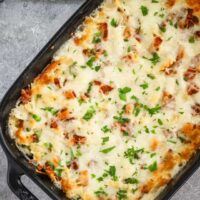 Chicken bacon ranch casserole freshly baked with a cheese and bacon topping.