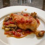 a serving of chicken breast with a tomato and mushroom sauce