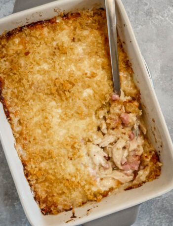 chicken cordon bleu casserole in the baking dish with spoon
