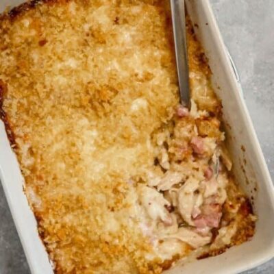 chicken cordon bleu casserole in the baking dish with spoon