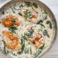 Creamy chicken and spinach in a skillet.
