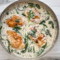 Pan-seared chicken breasts in creamy spinach sauce.