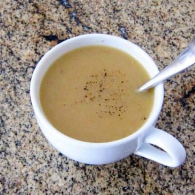 chicken gravy in a cup with spoon