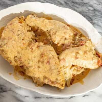 chicken paprikash with sour cream and paprika in a serving dish.