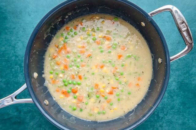 preparing the filling for a chicken pot pie.