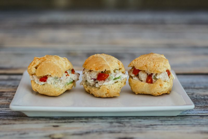 a trio of choux pastry puffs with chicken salad filling
