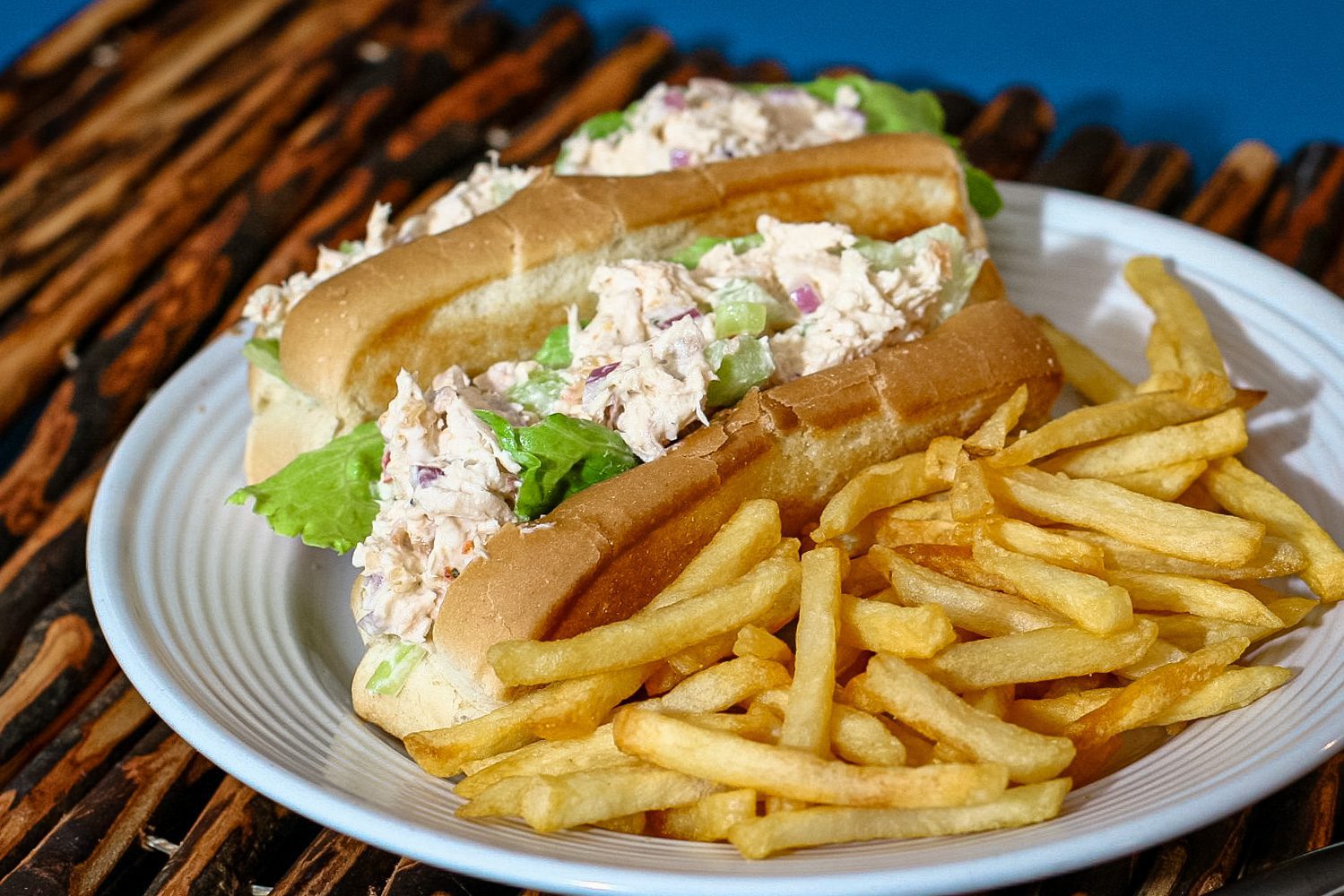 chicken salad sandwiches on buns with French fries on the side