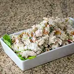 Creamy chicken salad with chopped vegetables and herbs.