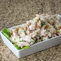 Creamy chicken salad with chopped vegetables and herbs.