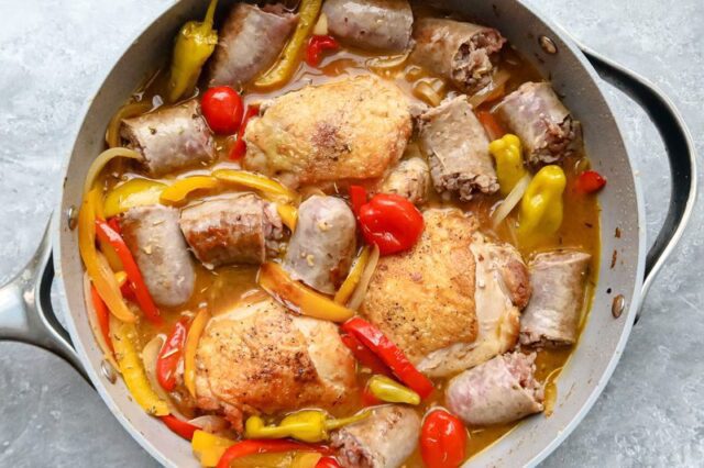 Chicken and sausages are added back to the skillet.