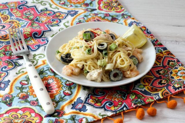 chicken and shrimp pasta salad with angel hair pasta, lemon, olives, and green onions