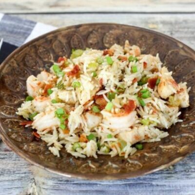 chicken rice pilaf with shrimp and bacon on a plate
