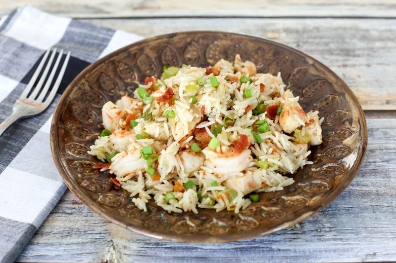 chicken rice pilaf with shrimp and bacon on a plate