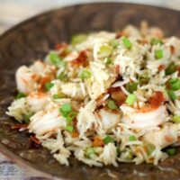 chicken rice pilaf on a plate with shrimp and bacon included