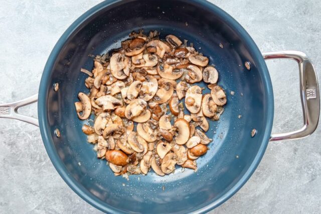 Sautéing mushrooms in a skillet.