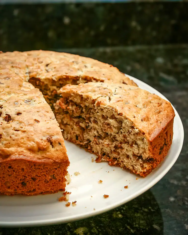 Homemade banana nut bread with visible nuts and moist texture.