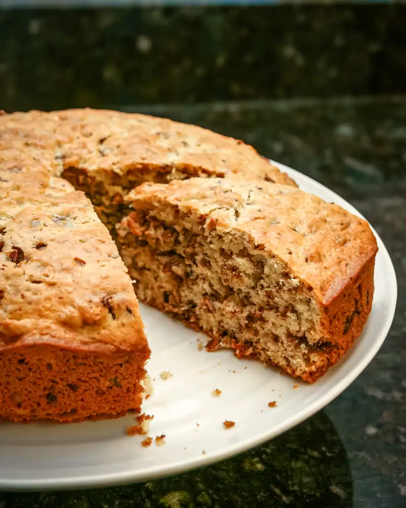 Homemade banana nut bread with visible nuts and moist texture.
