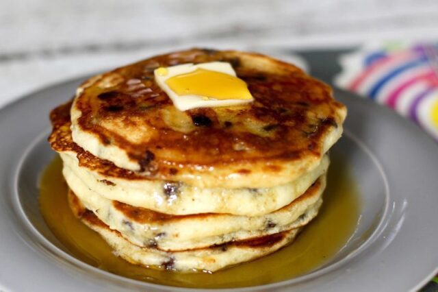 stack of chocolate chip pancakes with syrup