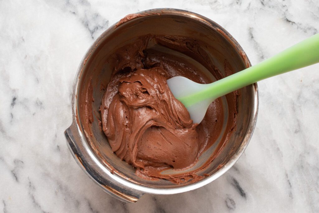 Mixing chocolate coconut oil frosting.