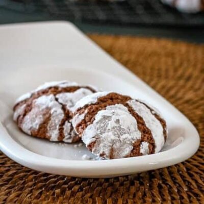 a small plate with chocolate crinkle cookies