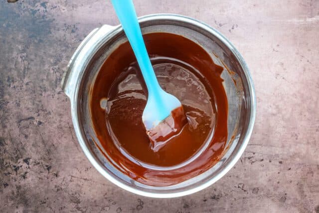 Chocolate fondant prep: melt the butter and sugar, then whisk in the flour.