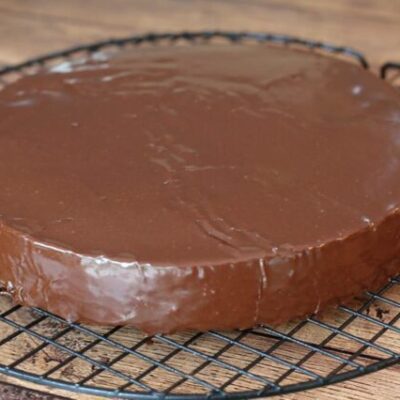 A cake layer covered with chocolate glaze
