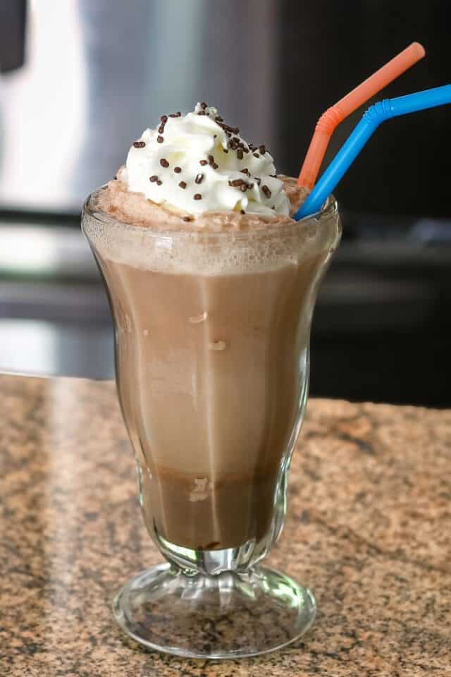 Creamy chocolate milkshake with whipped cream and sprinkles.