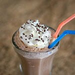 Creamy chocolate milkshake topped with whipped cream and sprinkles.