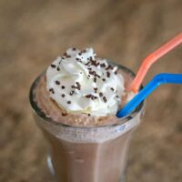 Creamy chocolate milkshake topped with whipped cream and sprinkles.