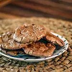 Rich chocolate chip cookies on a small dish.