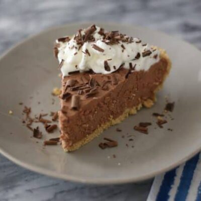 A chocolate amaretto pie garnished with whipped cream and chocolate