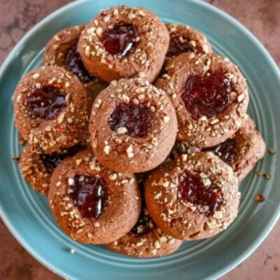 chocolate raspberry thumbprint cookies on a plate